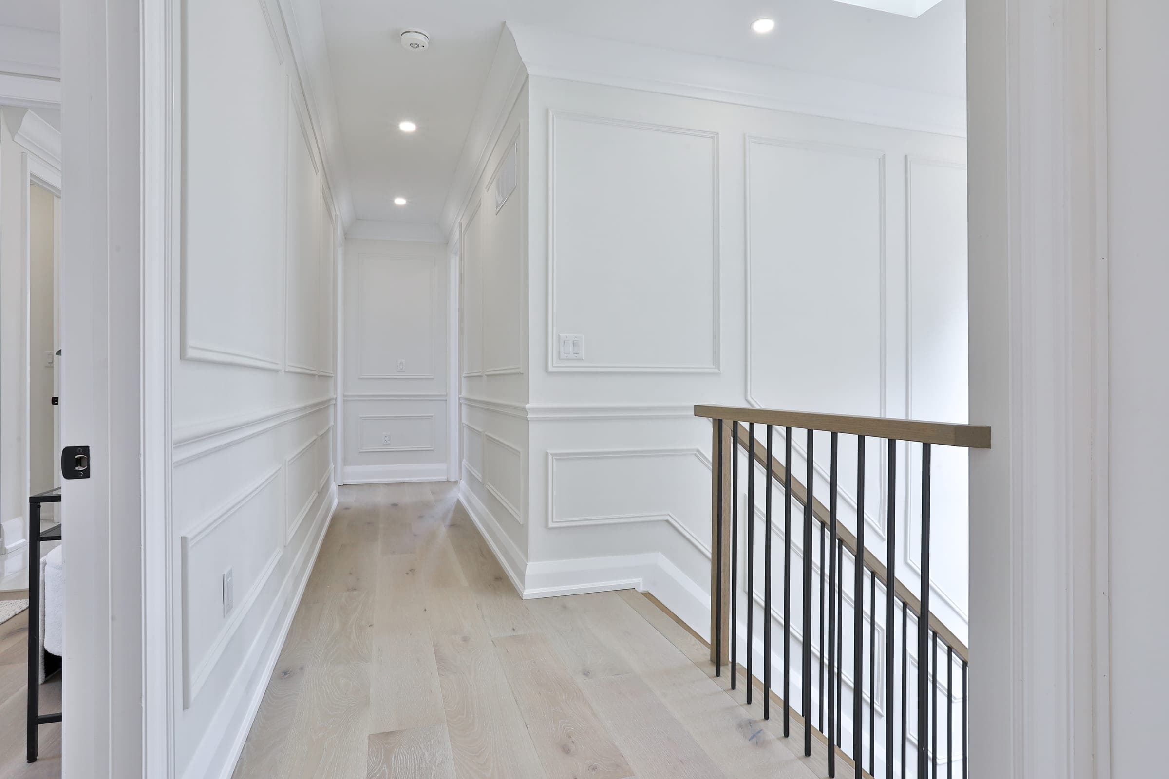 Sigma Painting — luxury interior hallway with crisp white wainscoting and trim
