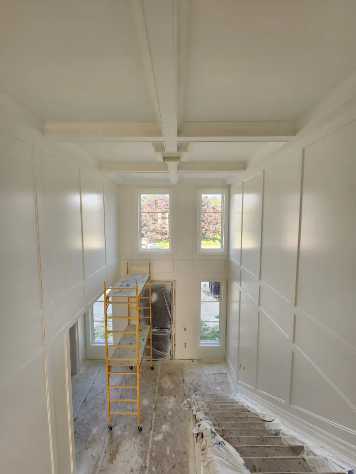 Interior painting by Sigma Painting — full-height wall panelling and coffered ceiling sprayed in off-white