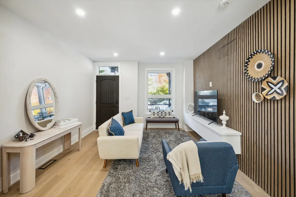 Interior painting by Sigma Painting — living room with slat feature wall and crisp white walls, Toronto