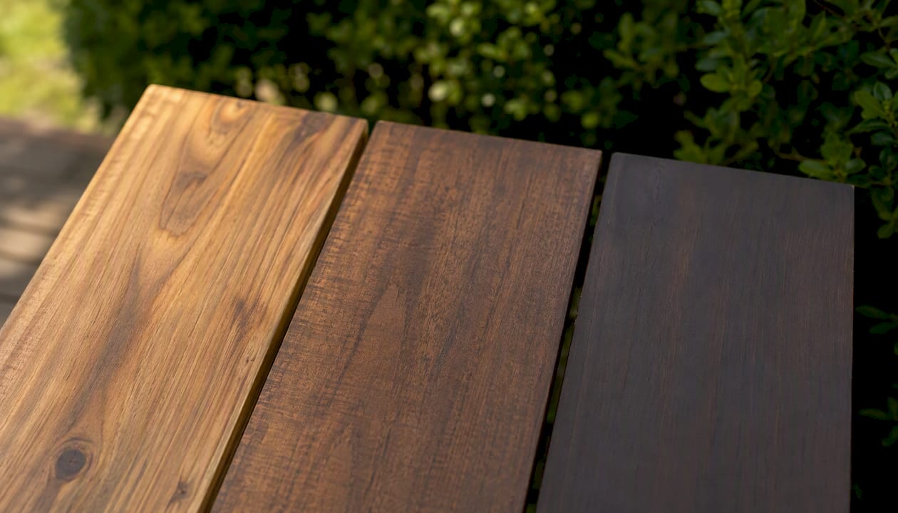 Close-up of cedar deck boards with different stain opacity